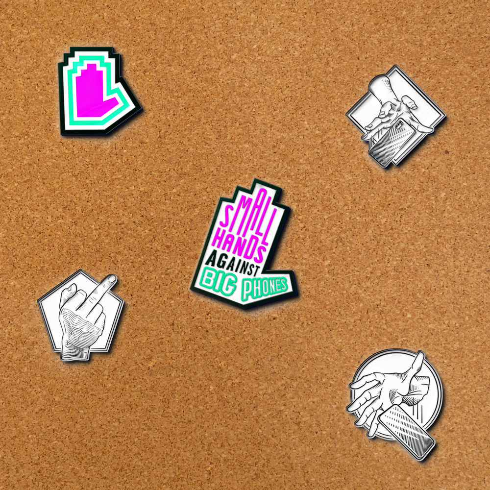 Enamel pins of SHABP's logo, favicon, two illustrations of a hand dropping a phone, and a middle finger